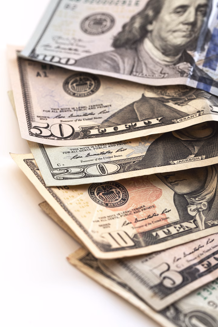 Money spread out on a white table.